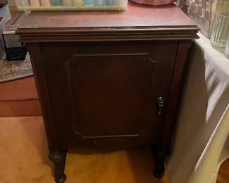 The White sewing machine cabinet closed