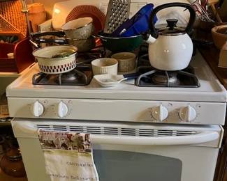 GE Gas stove with electric start, lot of new sauce pans, kettle, and kitchen items