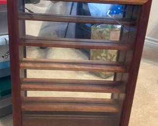 Display Rack is 15 3/4 inches wide. 21 1/2 inches tall. 4 inches deep. The glass shelf inside is 1 3/4 inches deep.