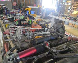 Grease guns and tape measures by the pile