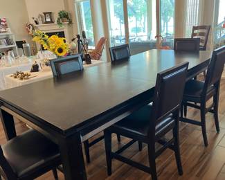30 $600.00 Black dining table 8'table incl. 1 leavex42Wx36T with 6 chairs counter height, 24Hx20Wx42T