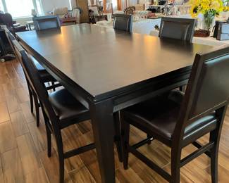 30 $600.00 Black dining table 8'table incl. 1 leavex42Wx36T with 6 chairs counter height, 24Hx20Wx42T