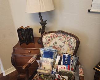 Side chair, night stand, lamp, ephemera and military kitsch.