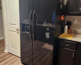 Side- by - side Black refrigerator with ice maker and filtered water dispenser