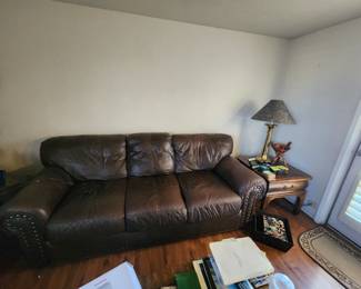 Brown leather couch, end table, and lamp
