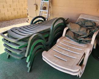 Green and white plastic lawn chairs
