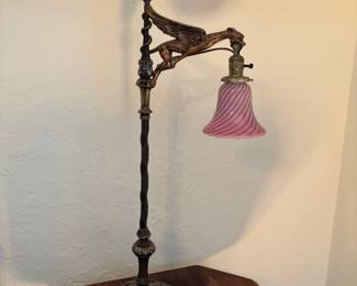Very unusual gargoyle bridge arm lamp 37 inches tall with Fenton swirl lampshade antique has a polychrome beautiful base on it.