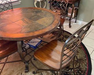 tile top round table with chairs and rug