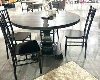 Round black dining table with 4 chairs