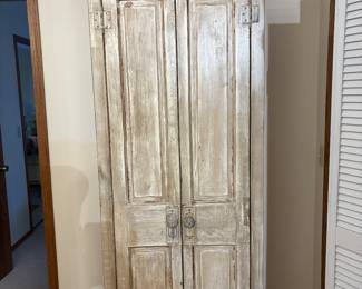 Wooden storage armoire. Has shelves on the inside. 
