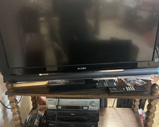 Large (~40") Sony flat screen TV, 3 x VCR. All in working condition with remotes. Pictured shelf is also for sale.
