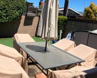 Patio table with six chairs and umbrella