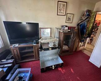 TV and TV cabinet, briefcases, trunk, storage cabinet, vintage rug, electronics, and more
