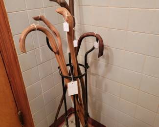 Selection of vintage walking sticks. One cane is an "advertising cane"...Cliff Martin Milling Co." & Purina Feed.