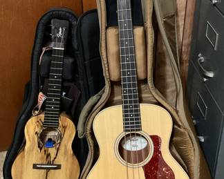 Taylor Guitars-GS mini bass (right). Romero Creations-GTMG-20059 solid wood Ukulele made in Vietnam (left)