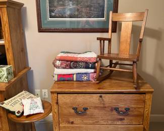 file cabinet, antique childs rocking chair, throw blankets, maple plant stand