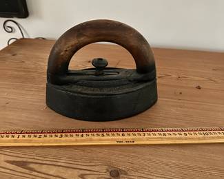 F28- $10. Wooden Handled Cast Iron, Vintage Iron. Measures 6.5" wide x 5.25" tall