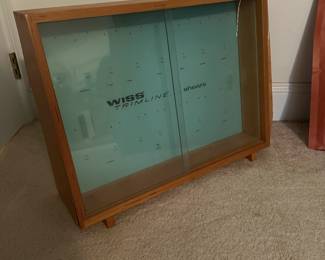 U68 - $60. Wiss Trimline Shears Store Display Case. Right side has veneer peeling that needs glue/repair. Sturdy - 2 glass doors slide. Measures 25.25" wide x 8" deep x 18.5" tall.