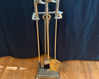 L43 - $75. Brass Fire Tool Set with Duck Heads. Measures 7.5" wide x 5.5" deep x 31" tall.