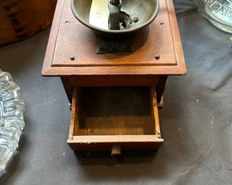 L28 - $35. Antique Coffee Grinder. Measures 9.5" wide (with handle) x 7.25" deep x 6.25" tall. Handle turns, drawer opens, very good condition!