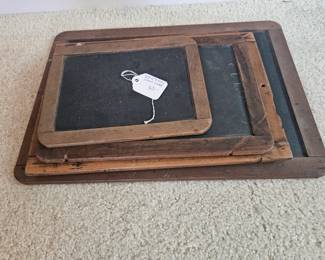 U15 - $50. Set of 5 Early school chalkboard slates. Largest measures 15.75" long x 11" wide, smallest measures 8.5" long x 6.5" wide.
