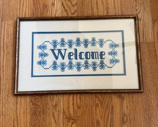 L47 - $25. Cross Stitch "Welcome". Measures 17.75" wide x 11.5" tall