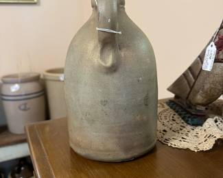 B22 - $50. J F Stratton Milford Mass Pottery Jug with handle. Measures 6" wide x 9" tall.