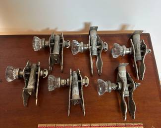 L68 - $200. Set of 12 doorknobs (6 with double handles & 6 single handles with locks). Names read Dexter & National Brass Co.