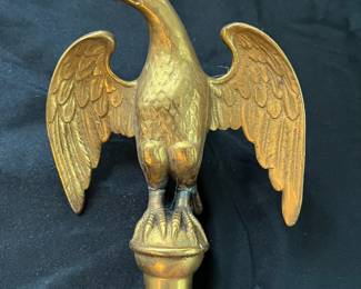 S25 - $50. Antique Brass Eagle Flagpole Topper. Measures 6" wide x 8" tall.