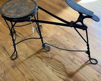 S43 - $60. Shoe Shine Stool. Wooden seat with wrought iron frame. Measures 24" long x 9.5" wide x 19.25" tall.