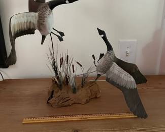 F13 - $25. Small Canadian Goose Carving by Clarance T. Sanders. Measures 14.5" wide x 12.5" tall.