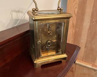 D58 - $275. Antique Brass Carriage Clock. E. Nowlan Co. Richmond, VA. Measures 3.25" wide x 2.5" deep x 5.5" tall with handle up.