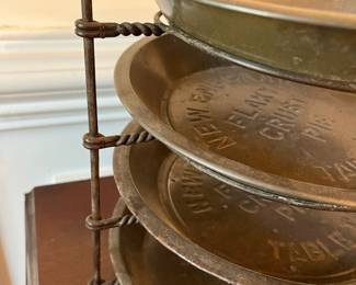 D43- $85. Antique Pie Rack 4 New England Pie Pans. Measures 11" wide x 10.5" tall.