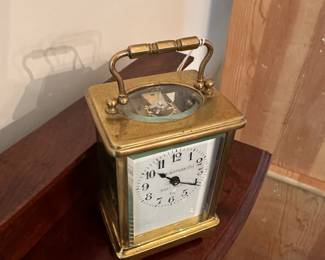 D58 - $275. Antique Brass Carriage Clock. E. Nowlan Co. Richmond, VA. Measures 3.25" wide x 2.5" deep x 5.5" tall with handle up.