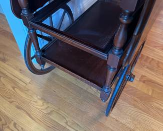 D57- $225. Vanleigh New York, Mahogany Tea-cart with Glass tray. Measures 28" wide x 18.35" deep x 28.25" tall. Handle folds down when not in use.