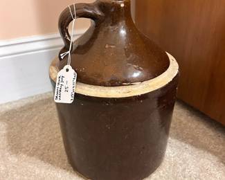 B15 - $25. Brown Stoneware Jug. Measures 7.25" wide x 11" tall.