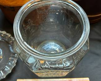 L29 - $50. Vintage Planters Pennant Peanut Jar. General Store Glass Jar. Measures 8" wide x 12.5" tall. Has minor chipping around the rim of the inside of the jar.