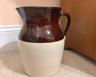 B14 - $30. Brown & White Pottery Pitcher. Measures 8.5" wide x 10" tall.