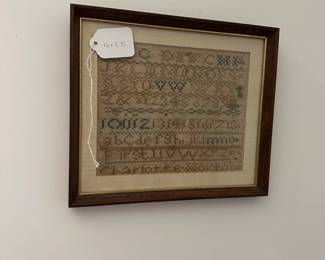 U32 - $50. Small Antique Sampler - Charlotte Worton. Measures 10" wide x 8.75" tall.