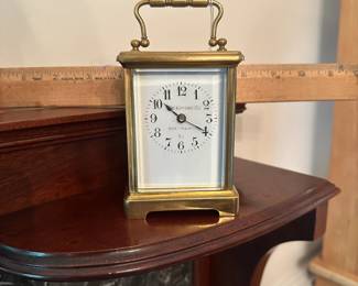 D58 - $275. Antique Brass Carriage Clock. E. Nowlan Co. Richmond, VA. Measures 3.25" wide x 2.5" deep x 5.5" tall with handle up.