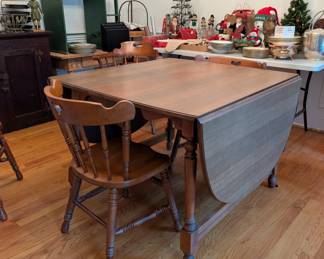 D1 - $150. Tell City Chair Co. Tell City Indiana. Drop Leaf Dining Table and Chairs. Measures 40.75" wide x 29.30 long (without leaves) Each side leaf measures 19.5" long and middle leaf measures 8.5" long. 6 Chairs.