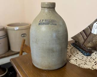 B22 - $50. J F Stratton Milford Mass Pottery Jug with handle. Measures 6" wide x 9" tall.