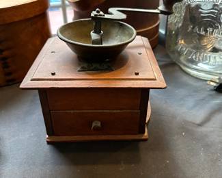 L28 - $35. Antique Coffee Grinder. Measures 9.5" wide (with handle) x 7.25" deep x 6.25" tall. Handle turns, drawer opens, very good condition!