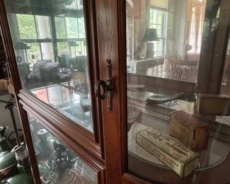 F20- $275. Pulaski Furniture Federal Style Cherry Illuminated Curio Cabinet. Measures 45" wide x 13" deep x 80.5" tall.