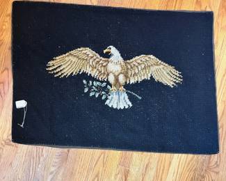 F39- $65. Eagle Needlepoint Rug. Measures 57" wide x 26" tall.