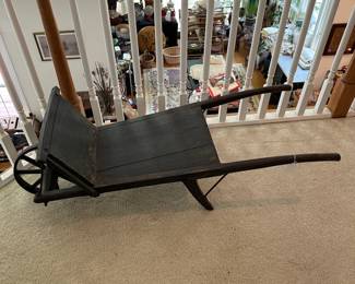 H6 - $125. Primitive Childs Wheelbarrow with removable sides. Metal Wheel. Measures 17.75" wide x 46 .25" deep x 17.25" tall
