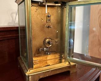 D58 - $275. Antique Brass Carriage Clock. E. Nowlan Co. Richmond, VA. Measures 3.25" wide x 2.5" deep x 5.5" tall with handle up.