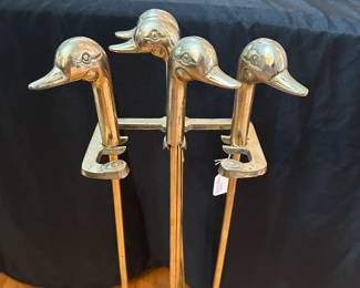 L43 - $75. Brass Fire Tool Set with Duck Heads. Measures 7.5" wide x 5.5" deep x 31" tall.