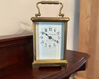 D58 - $275. Antique Brass Carriage Clock. E. Nowlan Co. Richmond, VA. Measures 3.25" wide x 2.5" deep x 5.5" tall with handle up.