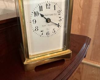 D58 - $275. Antique Brass Carriage Clock. E. Nowlan Co. Richmond, VA. Measures 3.25" wide x 2.5" deep x 5.5" tall with handle up.